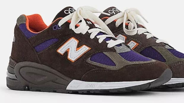 View of brown and purple New Balance shoes.